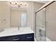 Updated bathroom with a vanity, a framed mirror and a tiled shower and tub combo at 8314 Stillbrook Ave, Tampa, FL 33615