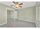 Bedroom with ceiling fan, mirrored closet, and window with natural light at 8314 Stillbrook Ave, Tampa, FL 33615