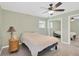 Cozy bedroom with ceiling fan, bedside table, and mirrored closet at 8314 Stillbrook Ave, Tampa, FL 33615