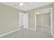 Empty bedroom with a ceiling fan and a mirrored closet at 8314 Stillbrook Ave, Tampa, FL 33615