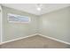 Empty bedroom with large window and neutral color scheme at 8314 Stillbrook Ave, Tampa, FL 33615