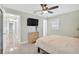 Comfortable bedroom features a ceiling fan, dresser, and mounted television at 8314 Stillbrook Ave, Tampa, FL 33615
