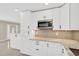 Modern kitchen boasts white cabinets, granite countertops, and stainless steel microwave at 8314 Stillbrook Ave, Tampa, FL 33615