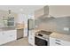 Bright kitchen features stainless steel appliances, granite counters, and sleek white cabinetry at 8314 Stillbrook Ave, Tampa, FL 33615