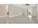 Spacious living room boasts polished concrete floors and a sliding glass door to the outside at 8314 Stillbrook Ave, Tampa, FL 33615