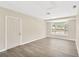 Bright, open living room with large window and modern flooring at 8314 Stillbrook Ave, Tampa, FL 33615