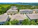 Bird's eye view of a residential area with modern townhomes, water views, and a cityscape backdrop at 842 Tennyson Mill Cir, Tampa, FL 33619