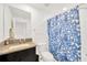 Bathroom features a single sink vanity with granite countertop and a blue patterned shower curtain at 842 Tennyson Mill Cir, Tampa, FL 33619