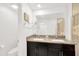 Bright bathroom features a double sink vanity with granite countertop and modern dark brown cabinets at 842 Tennyson Mill Cir, Tampa, FL 33619