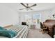 Bedroom with ceiling fan and two windows providing natural light, complemented by a workspace with a desk at 842 Tennyson Mill Cir, Tampa, FL 33619