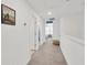 Upstairs hallway with carpeted floor and white walls leads to bedrooms and other living spaces at 842 Tennyson Mill Cir, Tampa, FL 33619