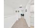 Upstairs hallway with carpeted floor and white walls leads to bedrooms and a laundry room at 842 Tennyson Mill Cir, Tampa, FL 33619
