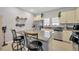 Open-concept kitchen with island, granite countertops and stainless steel appliances at 842 Tennyson Mill Cir, Tampa, FL 33619
