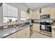 A well-equipped kitchen with stainless steel appliances and granite countertops at 842 Tennyson Mill Cir, Tampa, FL 33619