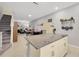 Modern kitchen with ample counter space, an island, and open access to living and dining areas at 842 Tennyson Mill Cir, Tampa, FL 33619