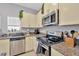 Well-lit kitchen boasts stainless steel appliances and granite countertops at 842 Tennyson Mill Cir, Tampa, FL 33619