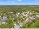 Aerial view of a residential area showcasing a beautiful home surrounded by lush greenery and mature trees at 9084 Quail Creek Dr, Tampa, FL 33647