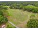 Aerial view showcasing a large grassy field with soccer goals, surrounded by trees and walking paths at 9084 Quail Creek Dr, Tampa, FL 33647