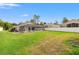 Spacious backyard featuring a screened pool enclosure and lush green lawn, perfect for outdoor enjoyment and relaxation at 9084 Quail Creek Dr, Tampa, FL 33647