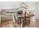 Bright dining and living area featuring wood floors, a large window, and neutral furnishings at 9084 Quail Creek Dr, Tampa, FL 33647