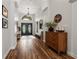 Spacious hallway with wood flooring, complemented by stylish decor and a view of the front entrance at 9084 Quail Creek Dr, Tampa, FL 33647