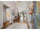 Inviting hallway with wood-look tile, arched ceilings, and views of the home's interior and backyard at 9084 Quail Creek Dr, Tampa, FL 33647