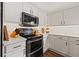 Modern kitchen featuring sleek white cabinets, subway tile backsplash, and contemporary appliances at 9084 Quail Creek Dr, Tampa, FL 33647