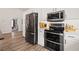 Modern kitchen with stainless steel appliances, white cabinets, and subway tile backsplash at 9084 Quail Creek Dr, Tampa, FL 33647