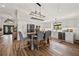 Spacious kitchen features white cabinets, modern appliances, and an island, seamlessly flowing into living area at 9084 Quail Creek Dr, Tampa, FL 33647