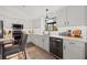 Well-appointed kitchen featuring sleek, stainless appliances, white subway tile, and elegant white countertops at 9084 Quail Creek Dr, Tampa, FL 33647