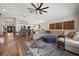 Open-concept living space with dining area, sectional sofa, and decorative wooden panels on the wall at 9084 Quail Creek Dr, Tampa, FL 33647