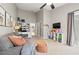 Spacious living room featuring comfortable seating, a study desk, and ample space for relaxation and play at 9084 Quail Creek Dr, Tampa, FL 33647