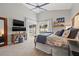 Comfortable main bedroom featuring a ceiling fan and direct access to the pool area via sliding glass doors at 9084 Quail Creek Dr, Tampa, FL 33647