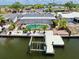 Aerial view of home with screened pool, dock and boat lift on canal at 916 Sago Palm Way, Apollo Beach, FL 33572