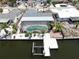 Waterfront home with a screened pool and dock, as seen from an aerial perspective at 916 Sago Palm Way, Apollo Beach, FL 33572
