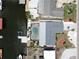 Stunning aerial view of waterfront property with pool, dock, and boat lift access to channel at 916 Sago Palm Way, Apollo Beach, FL 33572