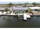 Aerial view of a waterfront home featuring a screened pool and dock for boating enthusiasts at 916 Sago Palm Way, Apollo Beach, FL 33572