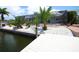Scenic backyard with a screened-in lanai, waterfront views, and lush greenery at 916 Sago Palm Way, Apollo Beach, FL 33572