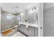 Modern bathroom featuring dual sinks, a glass-enclosed shower, and contemporary finishes at 916 Sago Palm Way, Apollo Beach, FL 33572