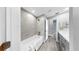 Modern bathroom featuring a shower-over-tub and a gray double vanity with sleek lines and light-colored flooring at 916 Sago Palm Way, Apollo Beach, FL 33572