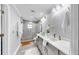 Bright bathroom with dual sink vanity, modern fixtures, and a glass-enclosed shower at 916 Sago Palm Way, Apollo Beach, FL 33572