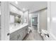 Renovated bathroom with double vanity, tiled accent wall, and tub-shower combo at 916 Sago Palm Way, Apollo Beach, FL 33572