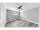 This is a cozy bedroom with a ceiling fan, wood floor, and white trim at 916 Sago Palm Way, Apollo Beach, FL 33572