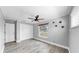This is a cozy bedroom with ceiling fan, wood floor, and white trim at 916 Sago Palm Way, Apollo Beach, FL 33572