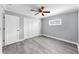 This is a cozy bedroom with a ceiling fan, wood floor, and white trim at 916 Sago Palm Way, Apollo Beach, FL 33572