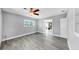 Bright bedroom with gray plank flooring leading into the dining room at 916 Sago Palm Way, Apollo Beach, FL 33572