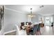Formal dining room featuring neutral walls, modern light fixture, and seating for six at 916 Sago Palm Way, Apollo Beach, FL 33572