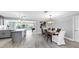 Open concept dining room boasts gray floors, and leads to the kitchen and outdoor pool area at 916 Sago Palm Way, Apollo Beach, FL 33572