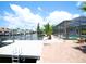 View of the dock over the canal with nearby screened-in patio at 916 Sago Palm Way, Apollo Beach, FL 33572