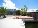 Dock with steps leading to an outdoor brick patio and screened-in pool area at 916 Sago Palm Way, Apollo Beach, FL 33572